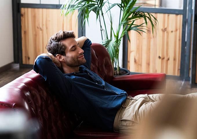 man relaxing on sofa hypnotised 