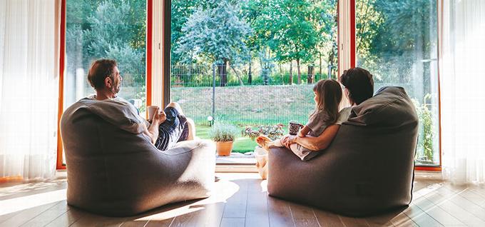 family sitting and talking by window