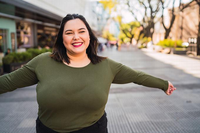 lady smiling with arms thrown wide open