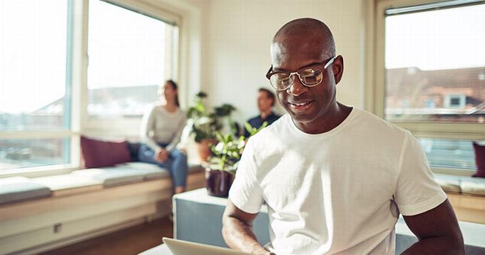 man on laptop smiling